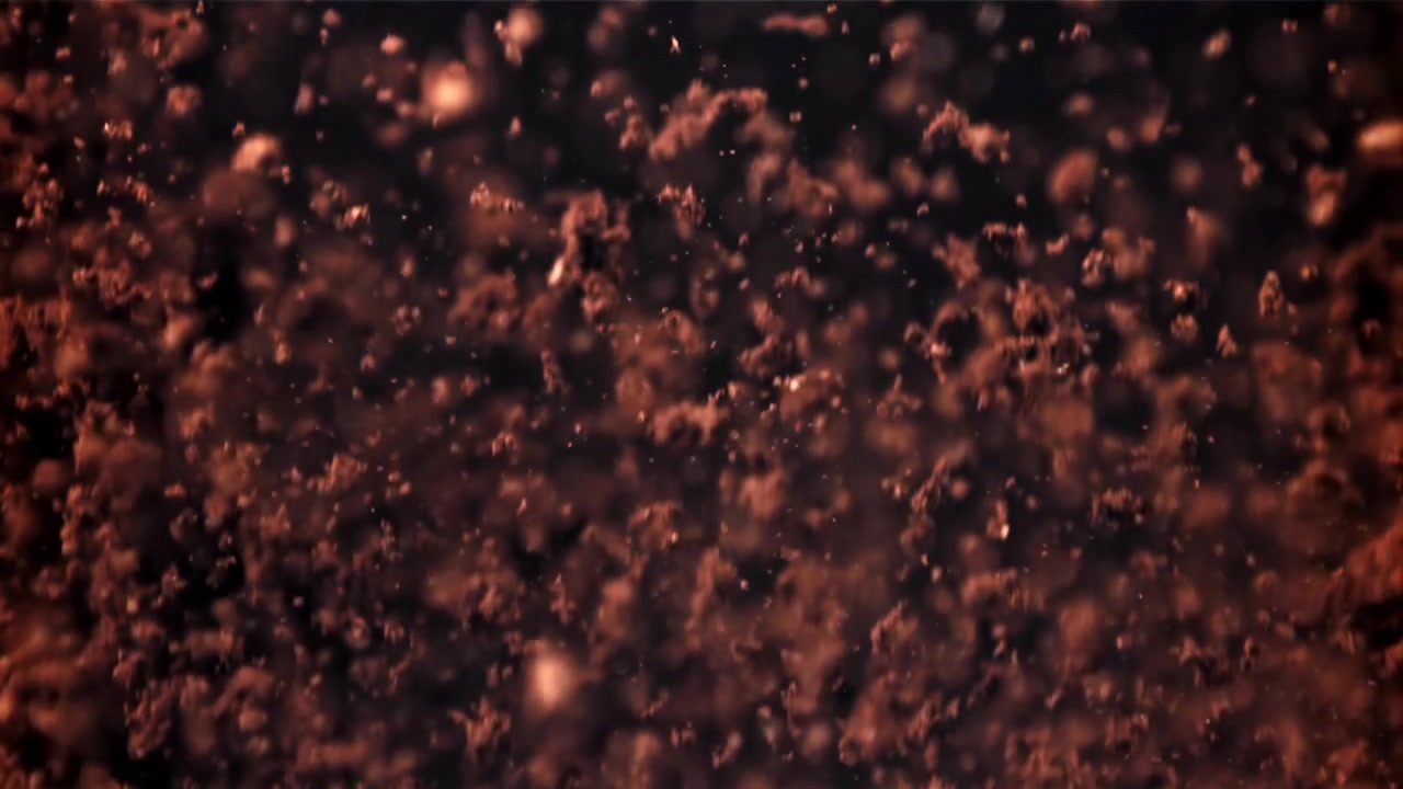 Abstract Reddish-Brown Particles Floating Upwards on a Dark Background