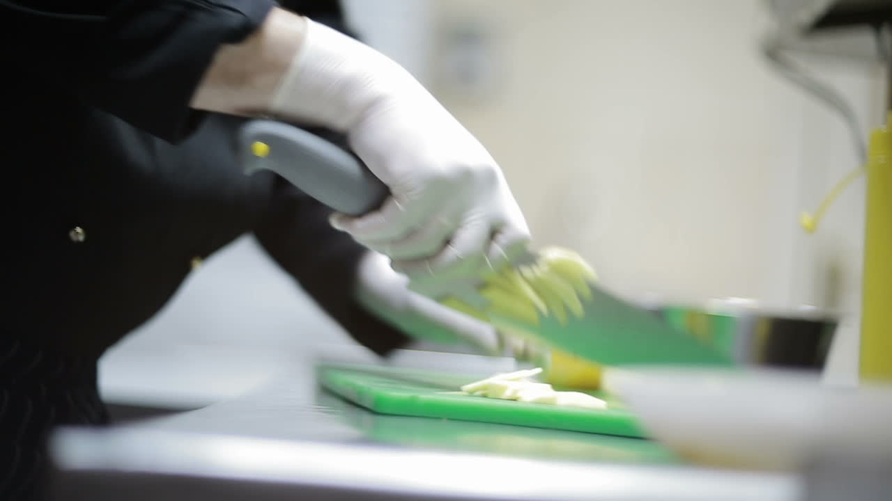 Chef Hands Cutting Potato. Chef hands cutting potato on table in kitchen