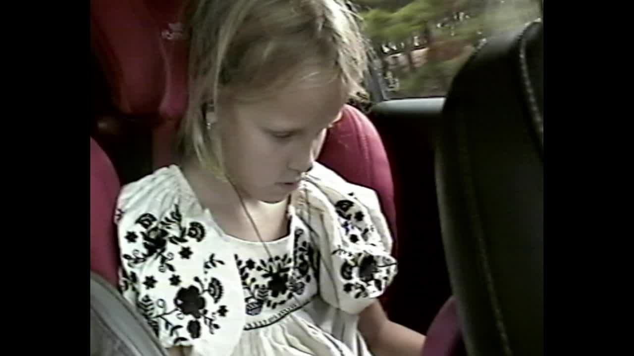 A young girl in a car seat