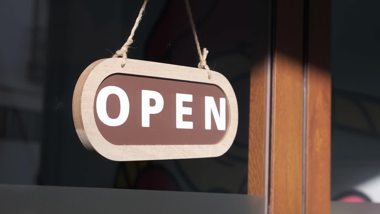 Small business opening up. Turning the sign from close to open. 4k 60fps