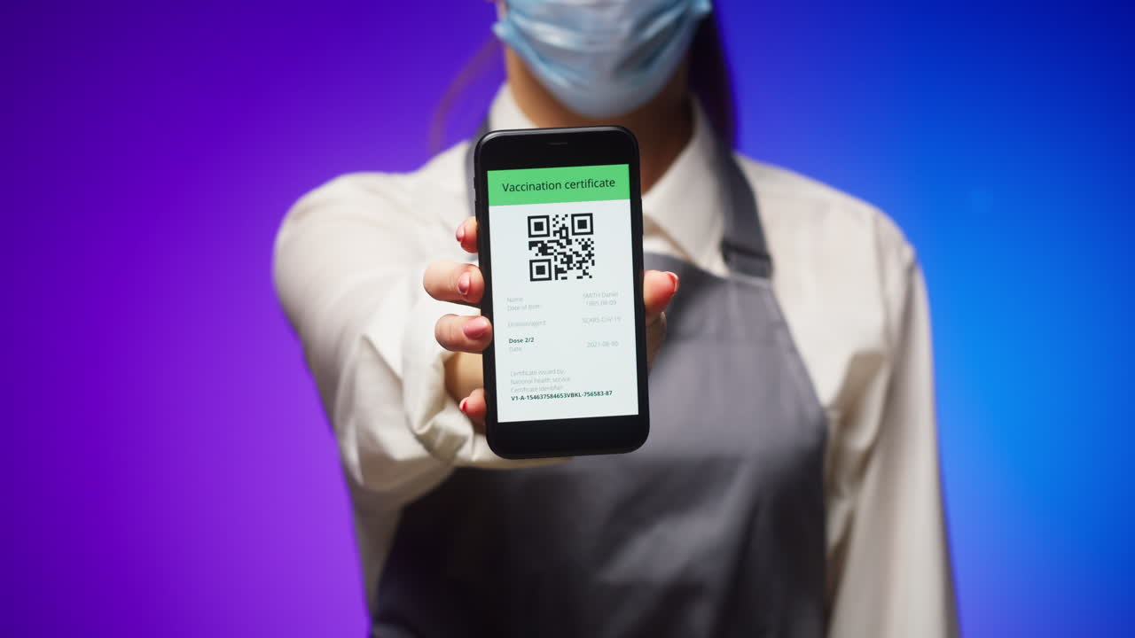 Person in Mask and Apron Shows Digital Vaccination Certificate on Smartphone