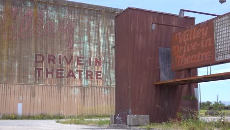 establishing shot of an abandoned drive in movie theater 2