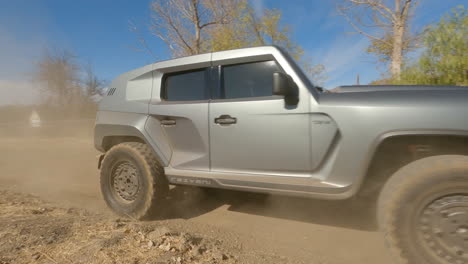 Circline-FPV-drone-shot-circling-around-a-new-police-car-kicking-up-dirt