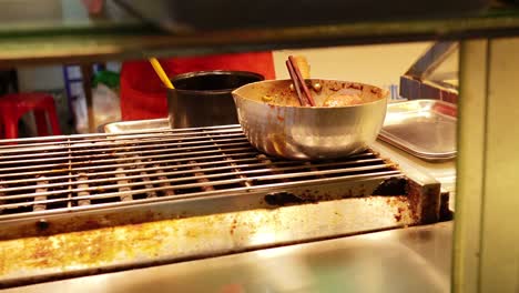 vendor grilling and preparing street food