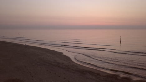 aerial shot of a calm northsea beach during sunset