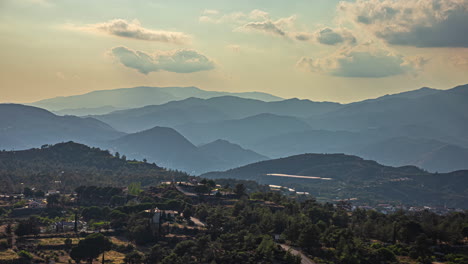 Hazy-sunset-over-the-forest-mountains-at-Limassol,-Cyprus---time-lapse