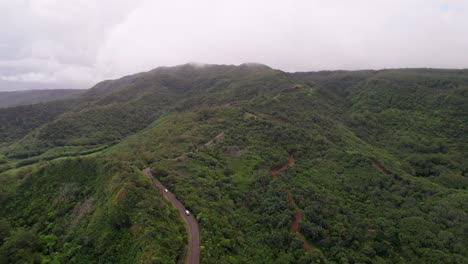 Lush-green-mountains-of-South-Mauritius-with-a-winding-road,-aerial-view