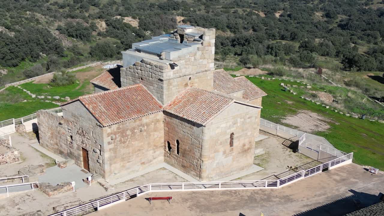 Orbital flight with drone in the hermitage of Santa María de Melque, 7th century in the province of Toledo, we see its area delimited with fences and reconstructions that have been carried out in it
