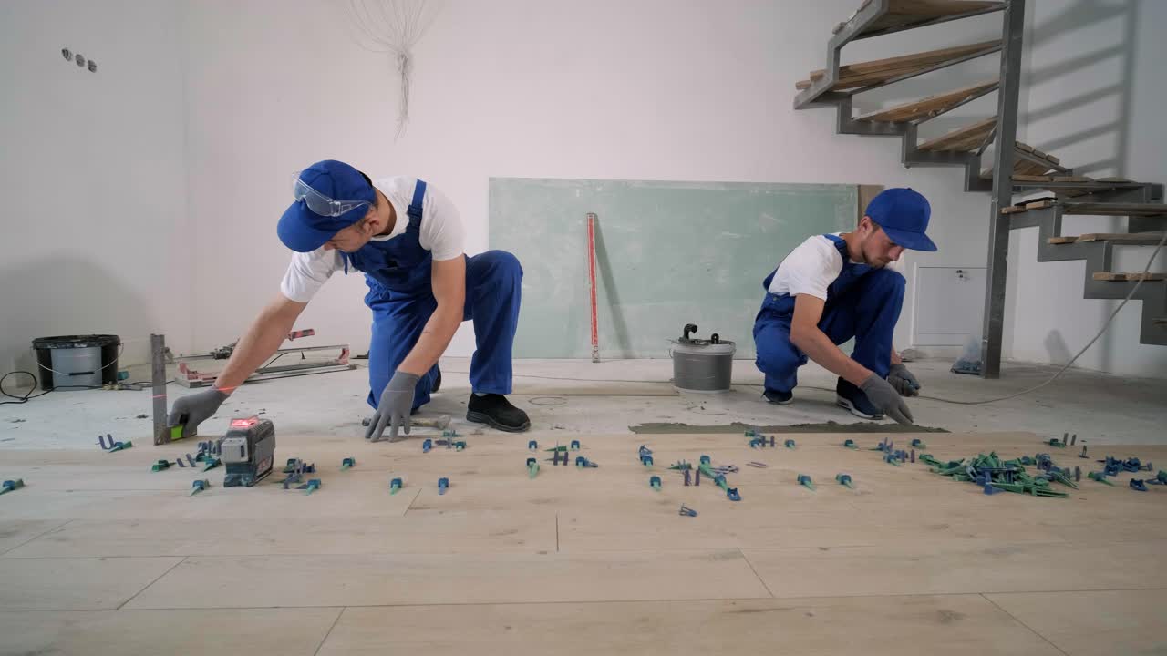 Installing ceramic floor tiles - measuring and cutting the pieces. Construction, renovation, repair apartment. Cuts tile. Tile cutting