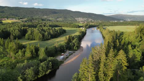 People-and-RV-Campers-Wild-Camping-at-River-in-Vestfold-og-Telemark,-Norway---Aerial-4k