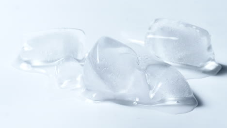 cold ice cubes melting time-lapse in white background