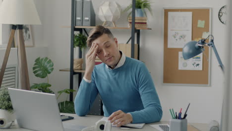 stressed young professional at desk