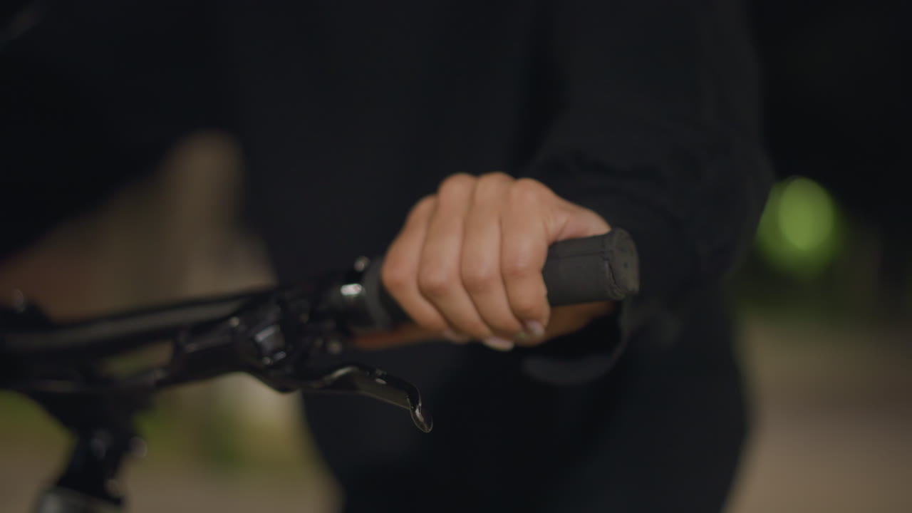 Steady Woman Guides Motorcycle Securely, Focused Rider Maintains Stable Control During Evening Ride, Serene Woman Carefully Manages Her Motorcycle With Unwavering Precision At Night