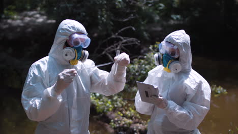 environmental scientists conducting water quality research in a forest