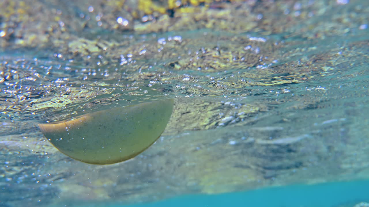 Underwater view of the waves and the bubbles of the red sea