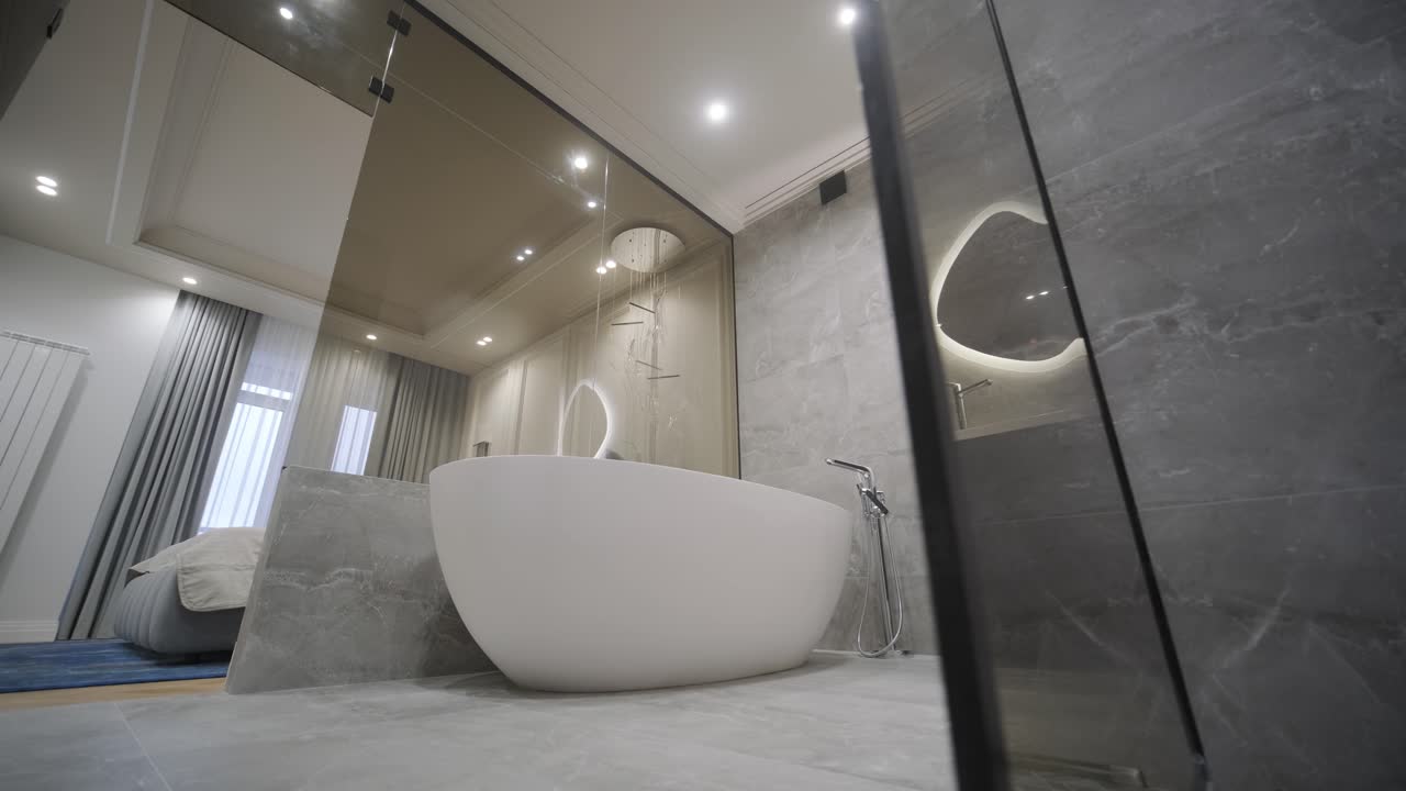 A spacious bathroom design featuring a sleek freestanding tub, illuminated mirror, and a walk-in shower with detailed tile work