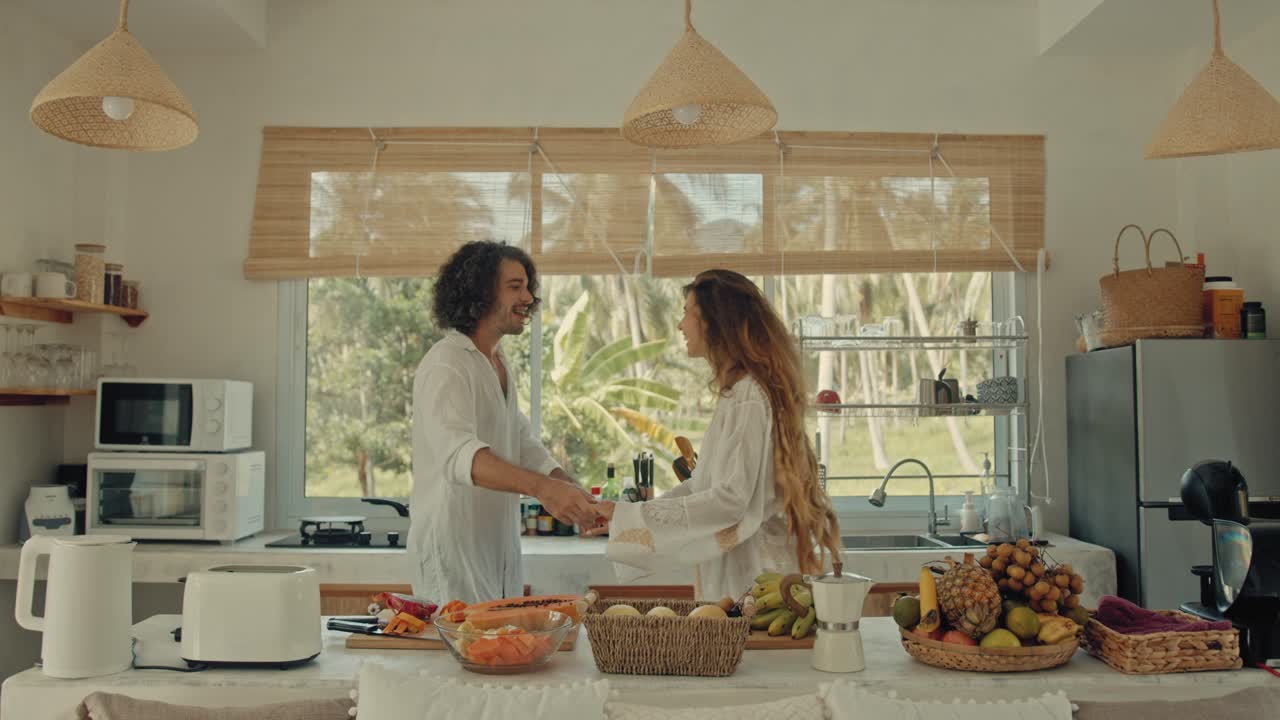 Couple enjoying a morning in a tropical kitchen