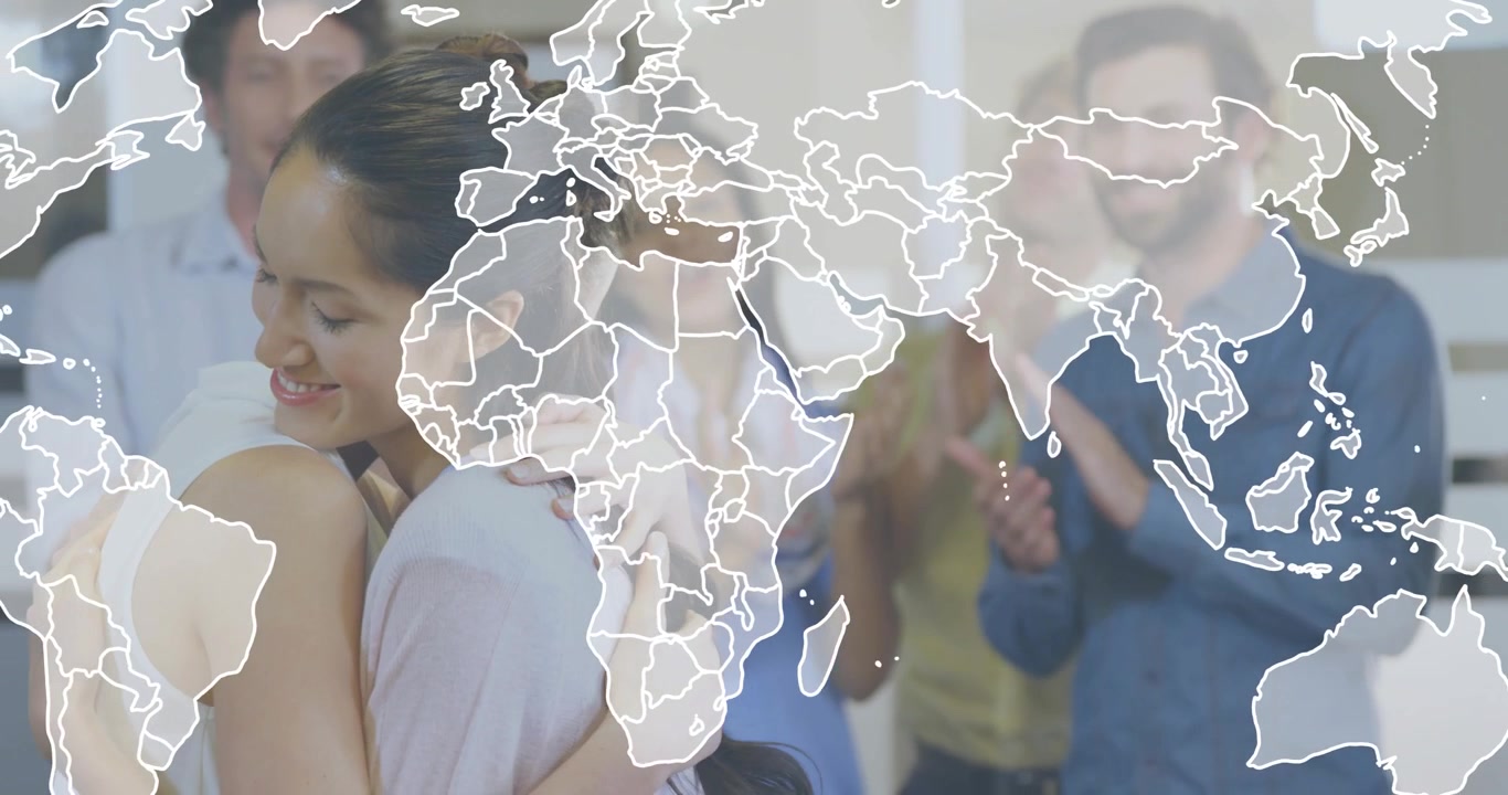 Team applauding sparking coworkers hugging in office with map overlay marking business milestone