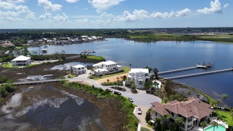 Panoramic drone movement around the private and luxury real estates with boat docks near calm bay, 30A, Florida, USA