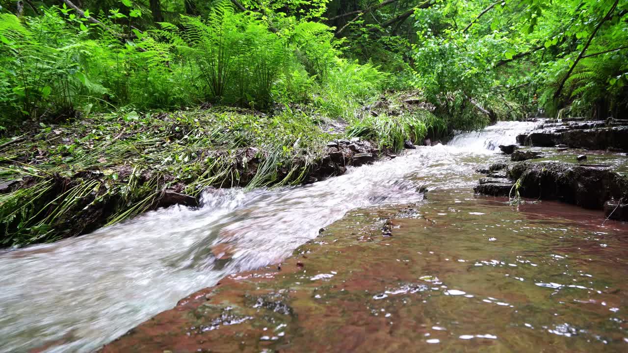 Waterfall in mountains forest falling to the broken