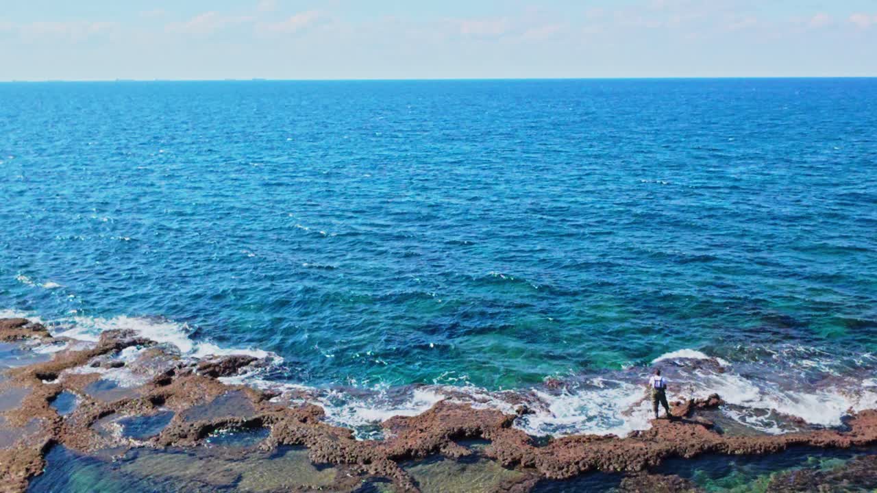 Akko's historic coastline featuring clear blue water and exposed rock formations