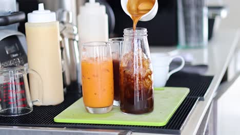 pouring milk into iced coffee in sequence