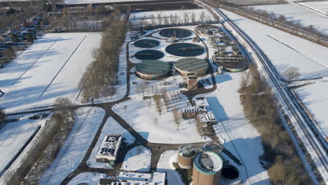 flying towards water basins at sewage treatment plant in winter