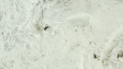 slowmotion shot of waves crashing against the shore