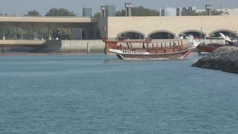 Old-wooden-Dhow,-boat-sailing-into-Qatar-docks