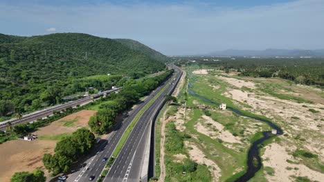 Elevated-view-of-a-scenic-stretch-of-the-highway-with-mountains-in-the-background