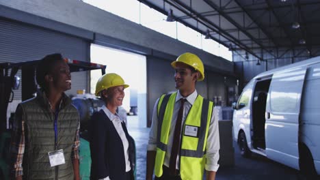 a diverse group of warehouse staff talking in loading bay 4k