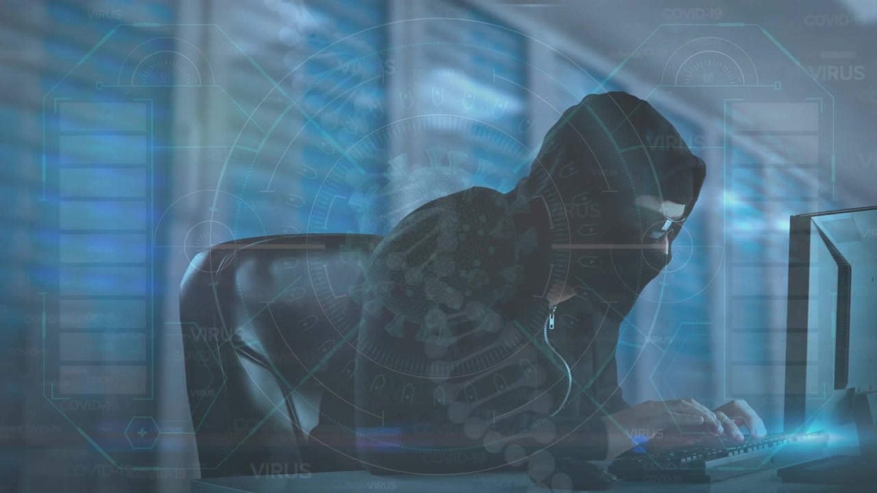 A hacker is using a laptop with data on the background