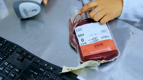 laboratory technician scanning blood bag with barcode scanner 4k