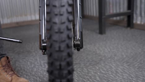 Mountain-bike-assembly-closeup---pushing-thru-axle-into-fork