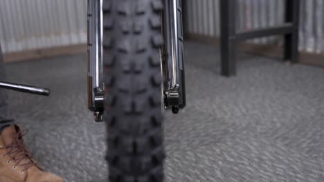 mountain bike assembly closeup - pushing thru-axle into fork