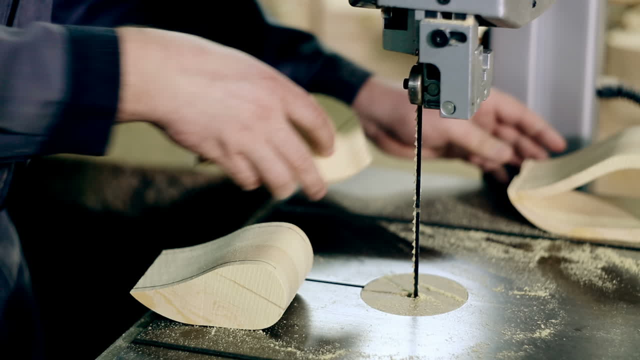 Man Cutting Wood Plank. Carpenter at work. Man cutting wood plank using electric jig saw.