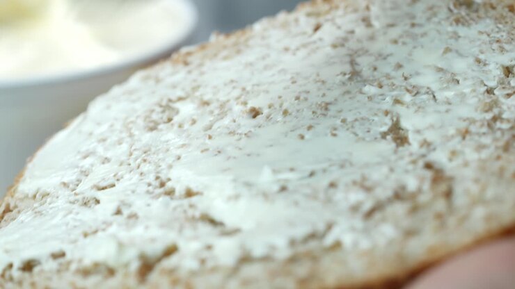 Low fact cheese cream in a container on table