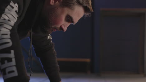 close up of a sportive man doing push ups in the gym