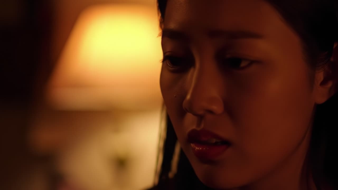 A Contemplative Moment: Capturing the Emotional Depth and Intrigue of a Woman Lost in Thought Under Soft Ambient Lighting