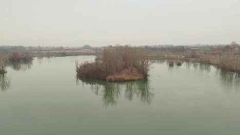 Aerial-–-Dramatic-and-Cinematic-revealing-shot-of-a-island-with-herons-flying-around