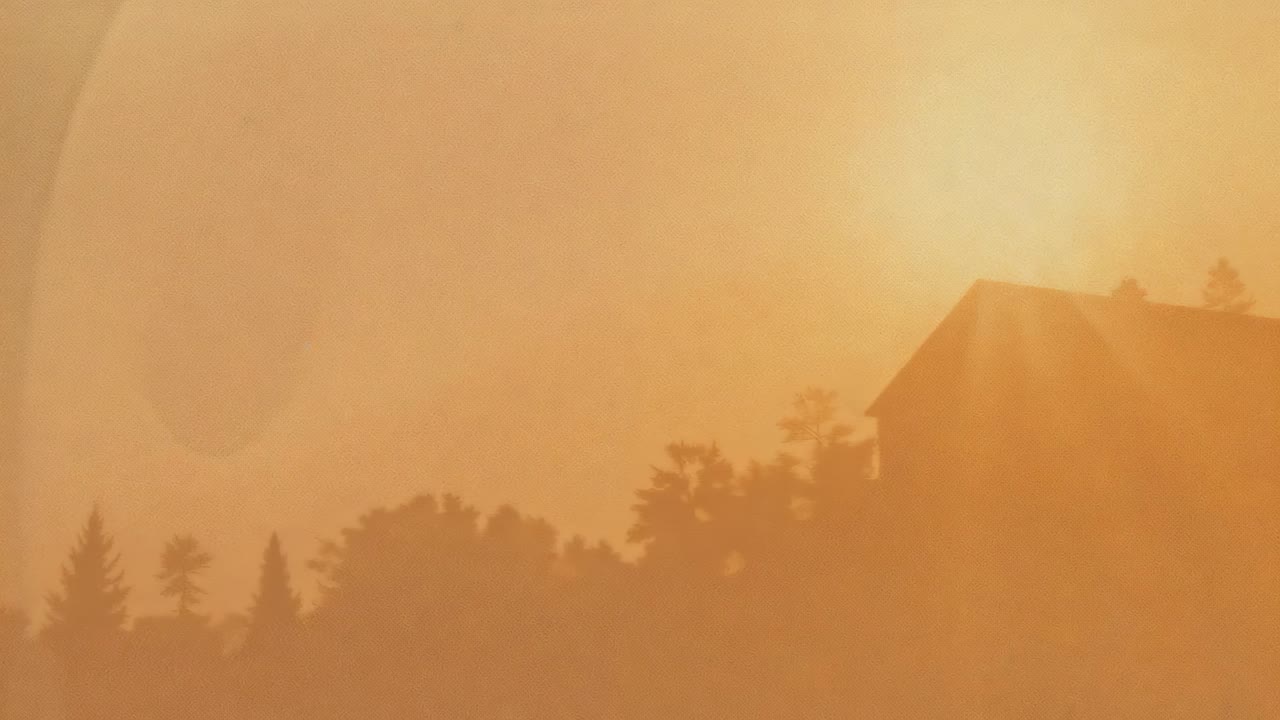 Shifting sun disk brightening, revealing rooftop silhouette and conifer at hillside, lens flare