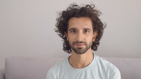 cheerful handsome curly haired young man