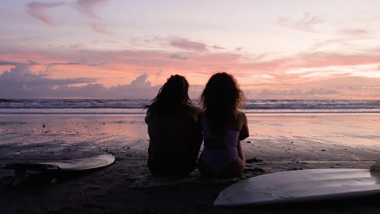 Young couple sitting on the sand