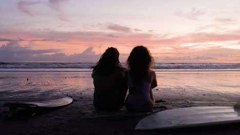 young couple sitting on the sand