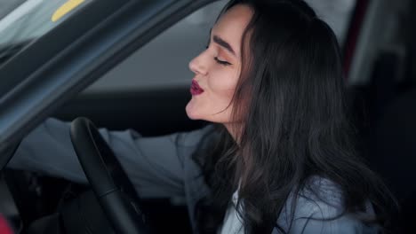 beautiful woman fascinatingly evaluates the car behind the wheel