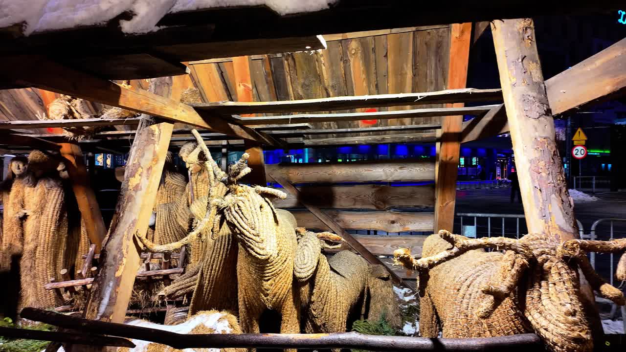 Wooden barn with straw animals and figures during christmas fair in Katowice city