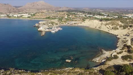 a drone shot lifts up and away from the harbor at rhodes in greece