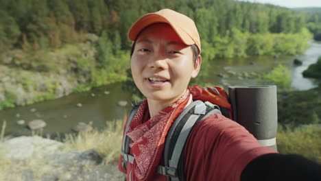 asian female hiker filming travel vlog