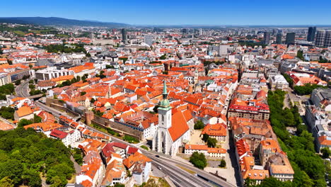 orange roofs of the old town in bratislava. aerial perspective on the historical part of the slovak capital on sunny day