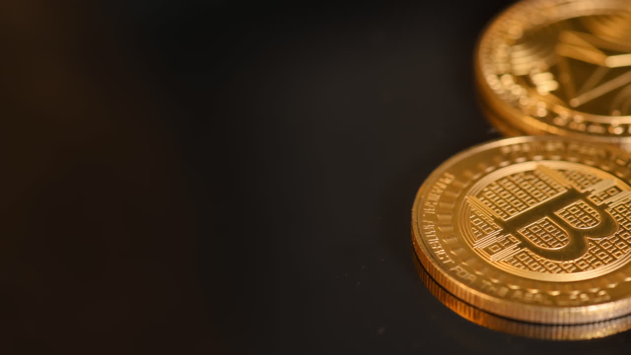 Close view of three golden physical crypto coins, Bitcoin, Litecoin